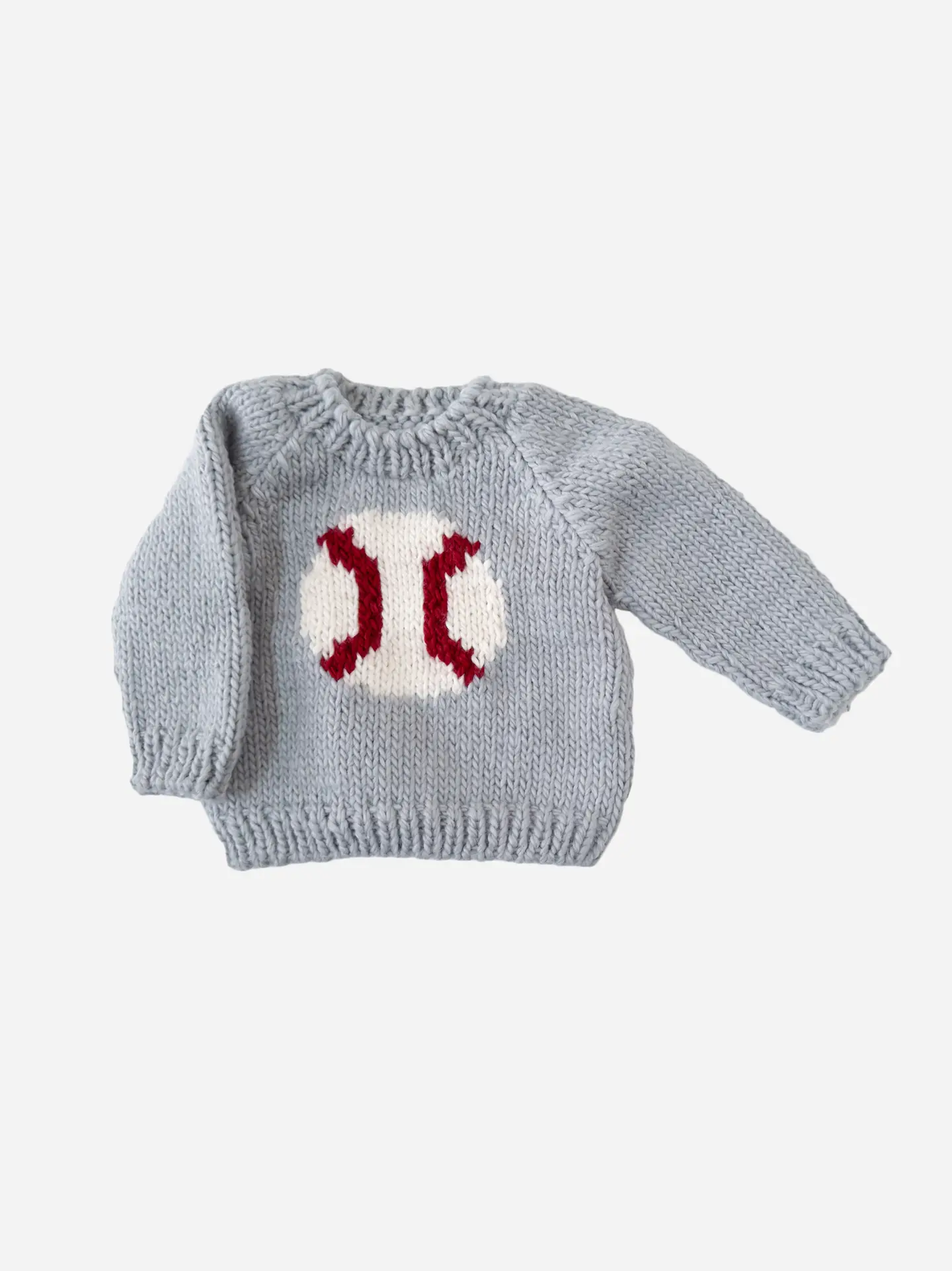 Gray knitted sweater with a red and white pattern on a light gray background