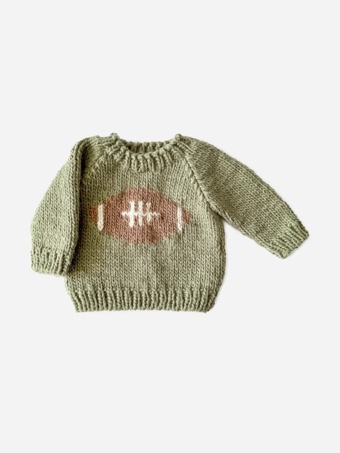 Knitted sweater with a football design on a light green background