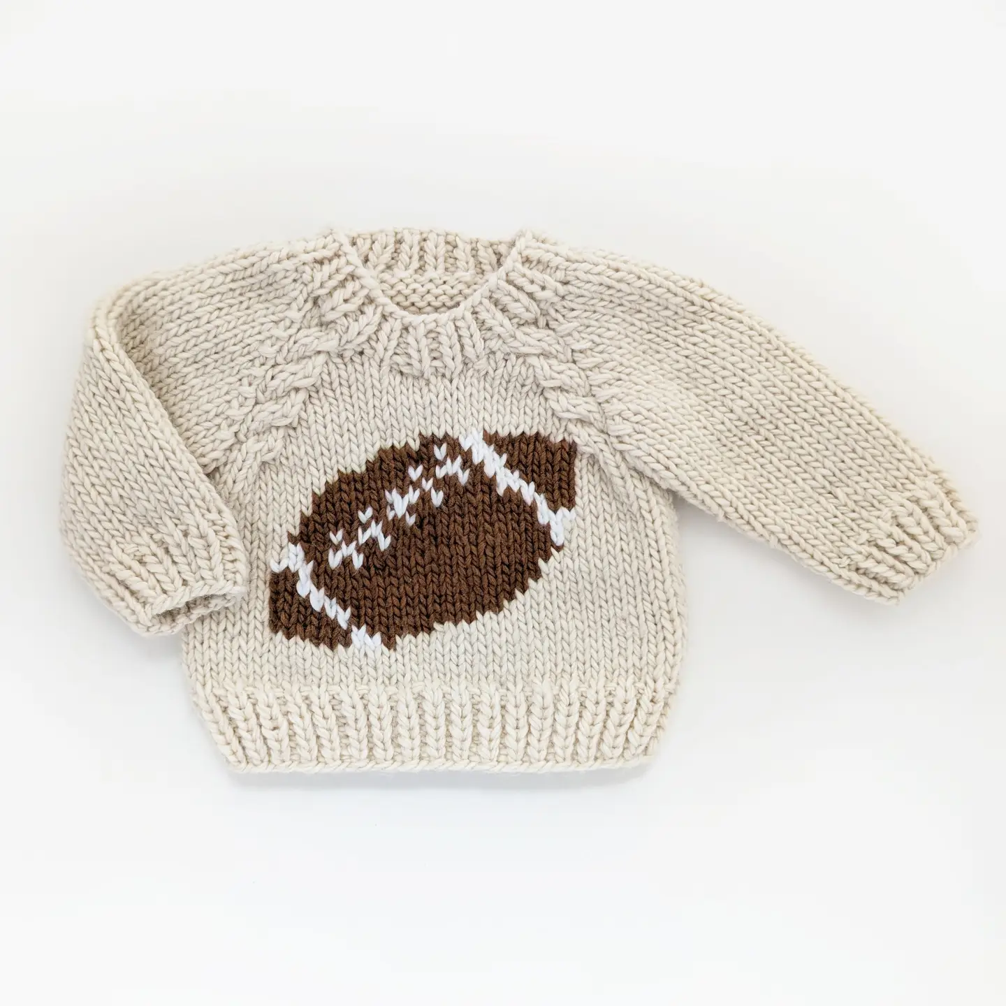 Knitted sweater with a football design on a white background