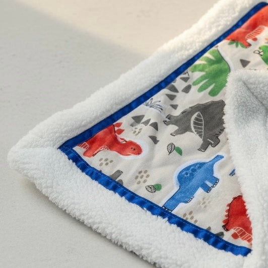 Baby blanket with animal pattern on a light gray background