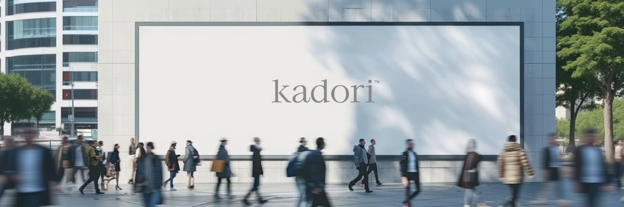 People walking on a street with a large 'kadori' sign in the background